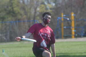 Reuben Gottesman ’24 shows off his throwing abilities as he unleashes the frisbee to one of his teammates. 