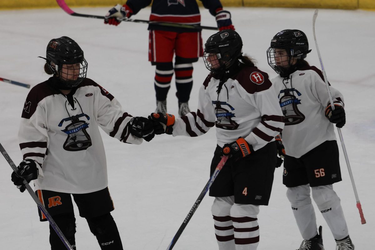 Teammates celebrate together after making a big play.