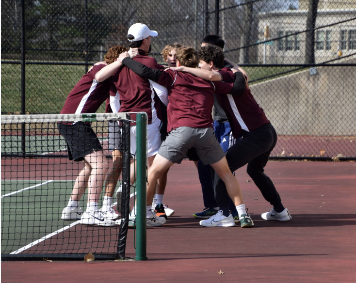 Team members huddle together to get hype for a match.